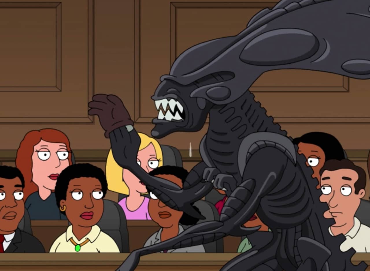 Xenomorph from Alien in front of a jury, trying on a glove that doesn’t quite fit