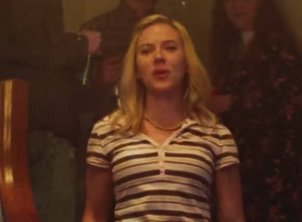 a teen girl stands on the stairs at a party