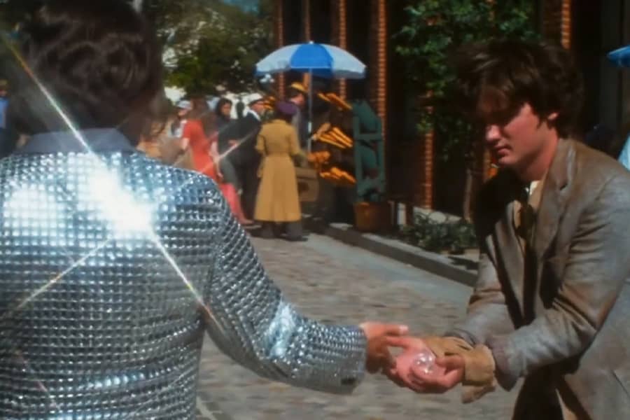 Diamond Jim hands a beggar some diamonds