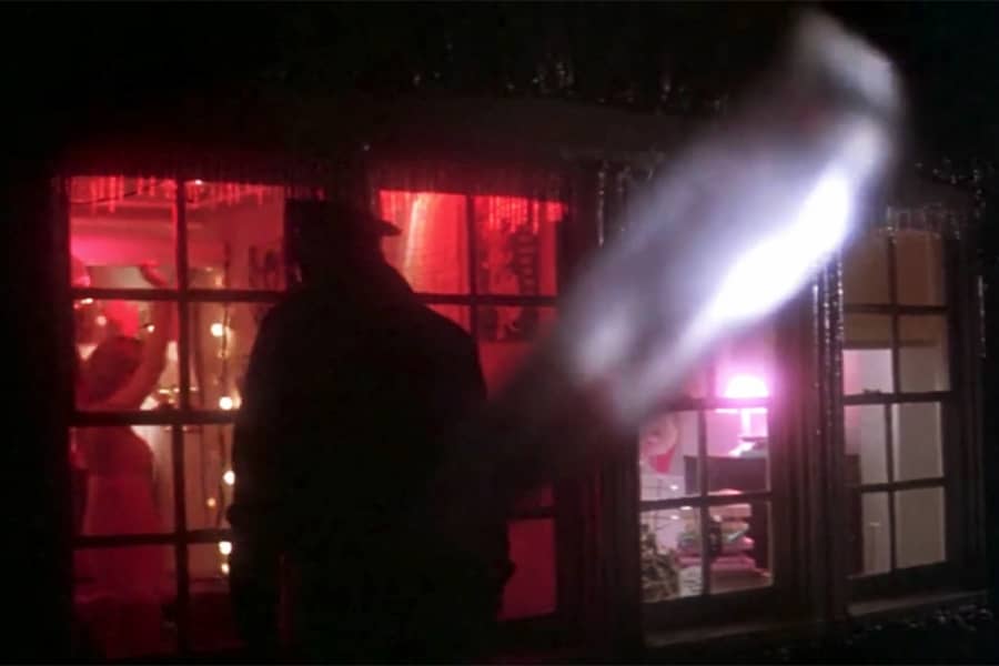 a cop peers into a window and a knife is pulled behind him