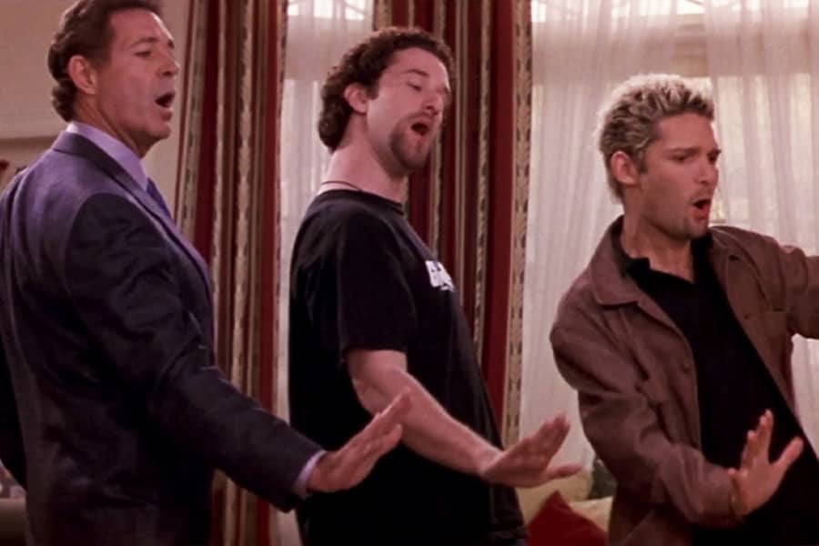 Dustin Diamond, Barry Williams, and Corey Feldman doing a coordinated hand motion