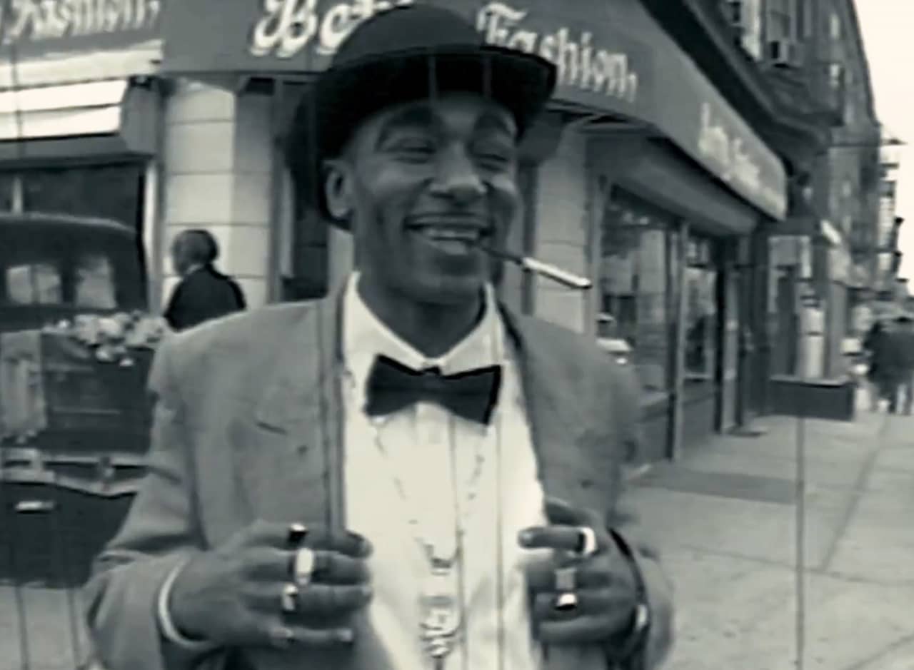 Fats Waller, a black musician wearing a bow tie and smoking a cigarette