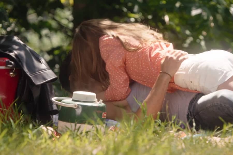 Corey and Tori kissing on the picnic blanket