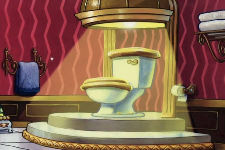 a fancy golden toilet with a spotlight on it