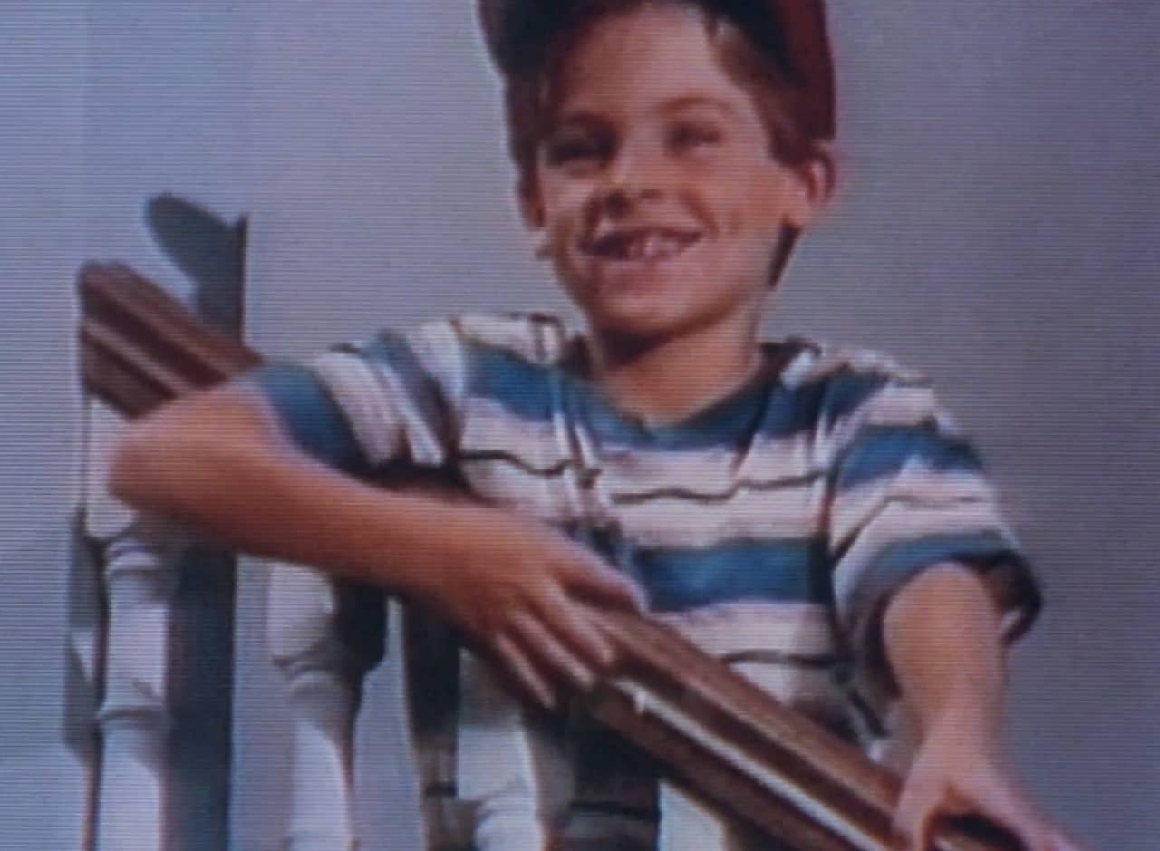 Mikey (a young boy, standing on the stairs