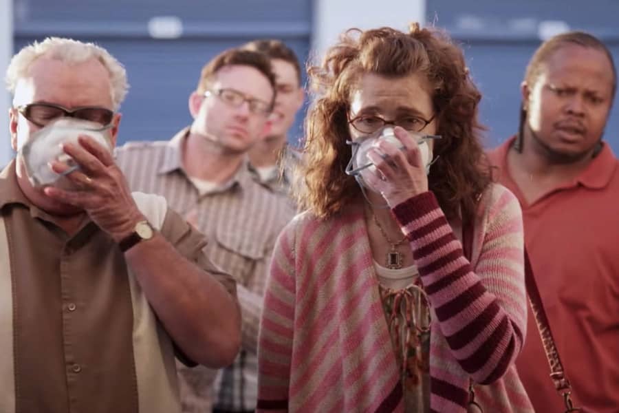 people hold dust masks up to their faces