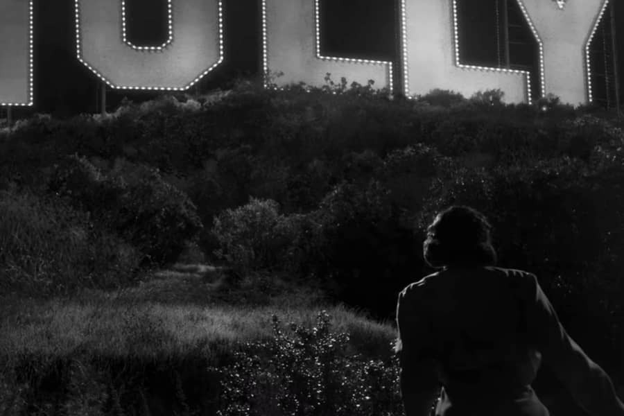 Meg climbs hill toward the Hollywoodland sign