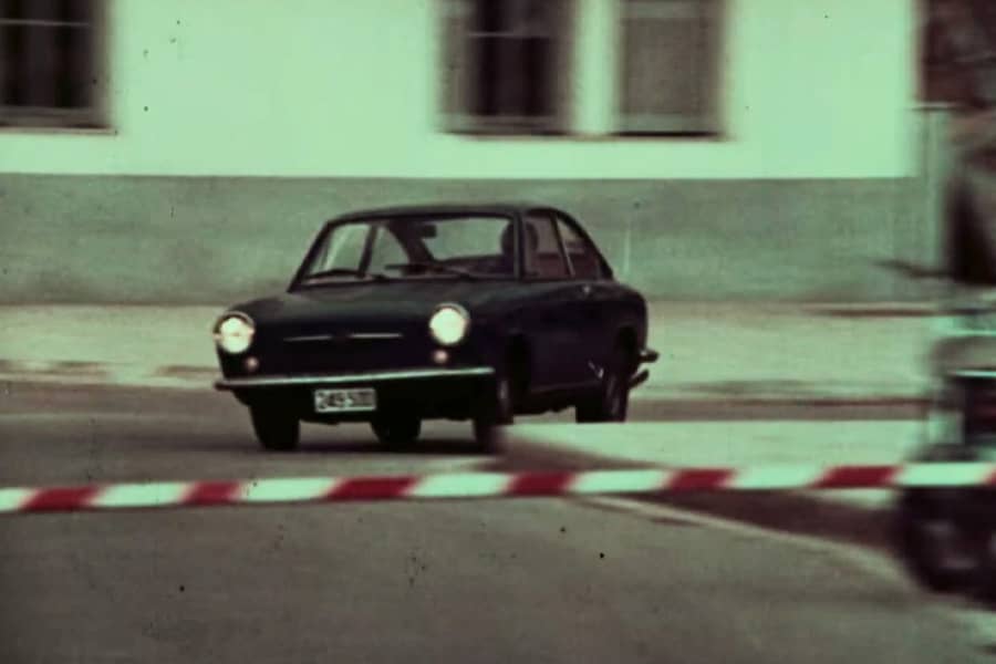 a car turns a corner toward a barricade