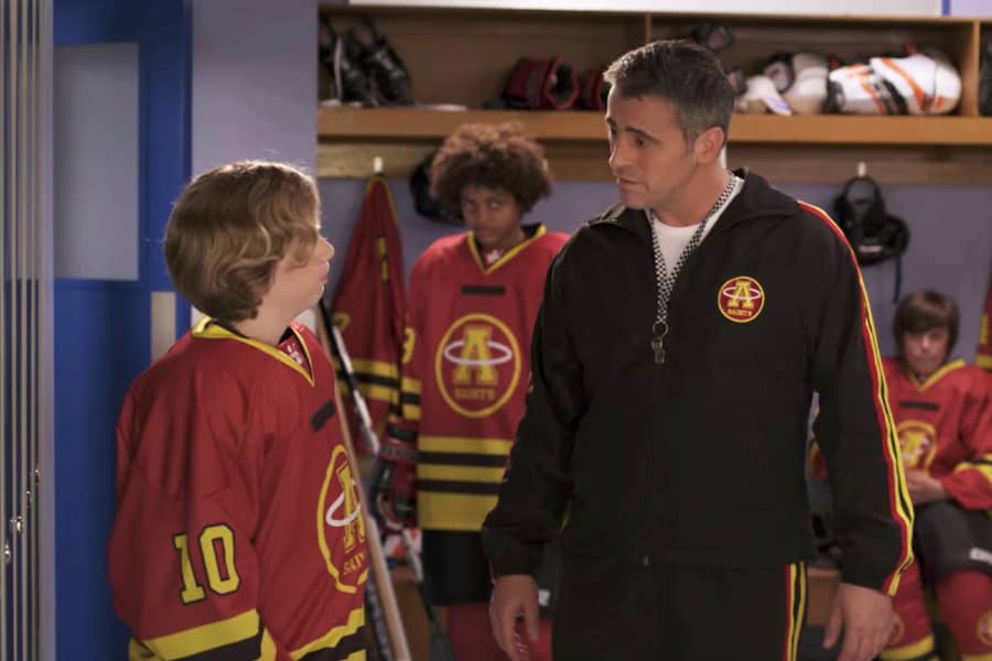 Lyman talks with a young player in the locker room