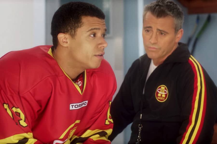 Lyman talks with another player in the locker room