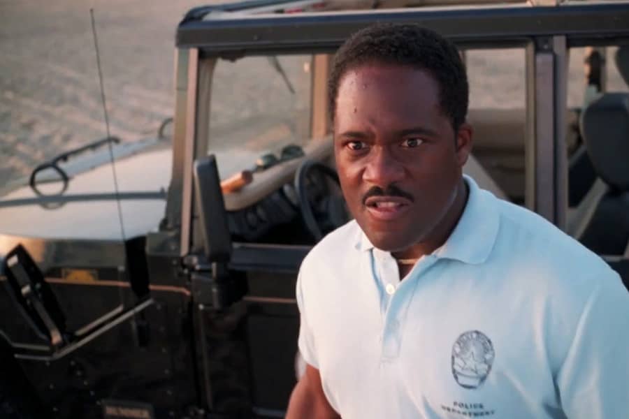 a beach patrolman by a Jeep