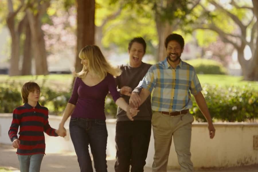 the family laughing walking through the park