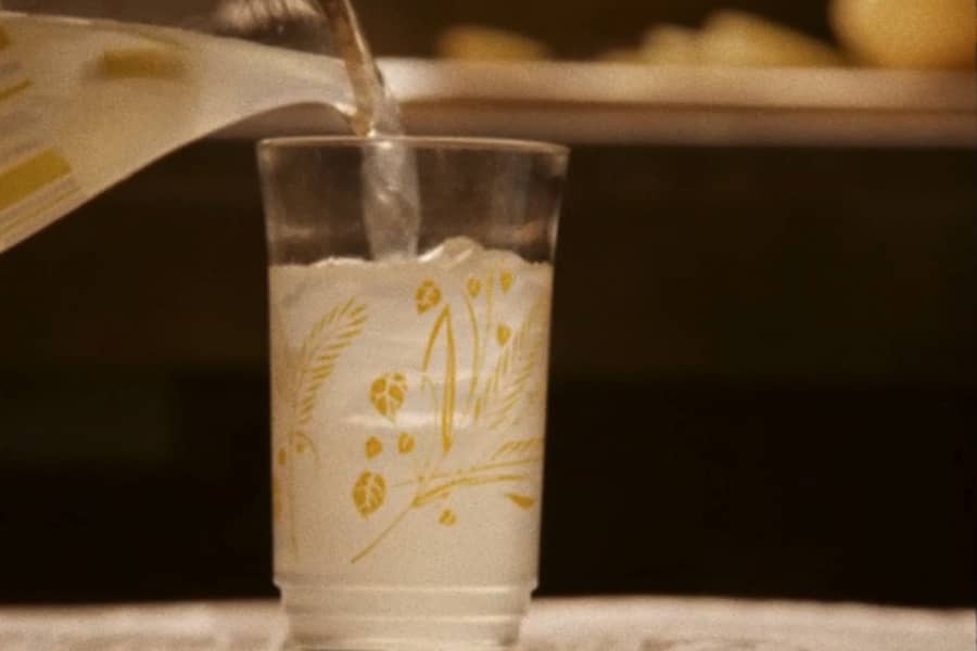 pitcher of lemonade pouring into a glass