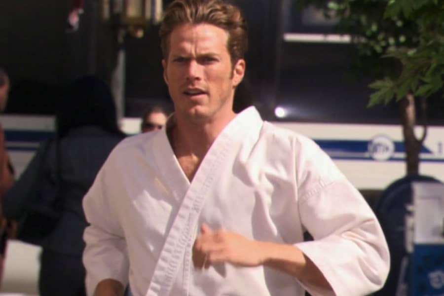 Tony runs down the street in his karate gi