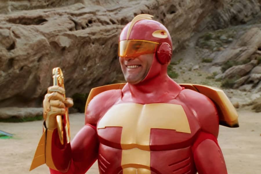 Turbo Man smiles holding a boomerang