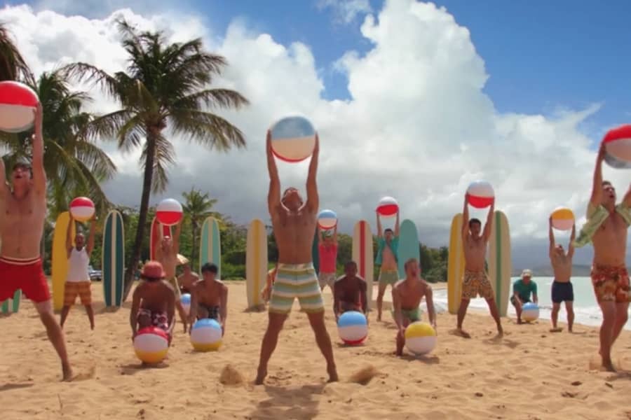 teens on the beach dancing with beach balls